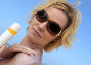 Woman applying sun screen